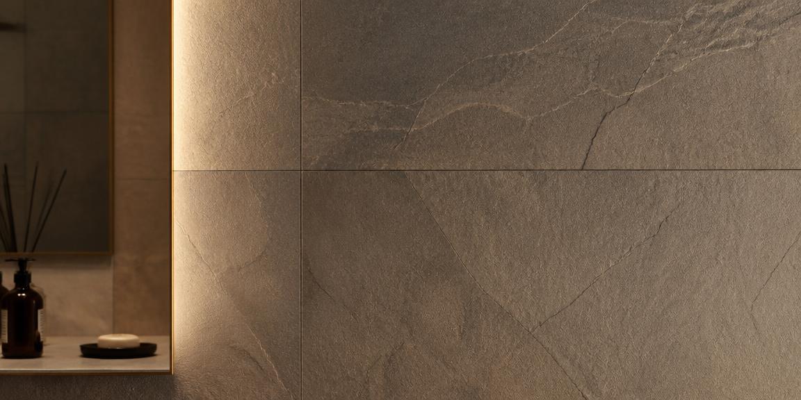 Large-format stone wall tile lit by warm light